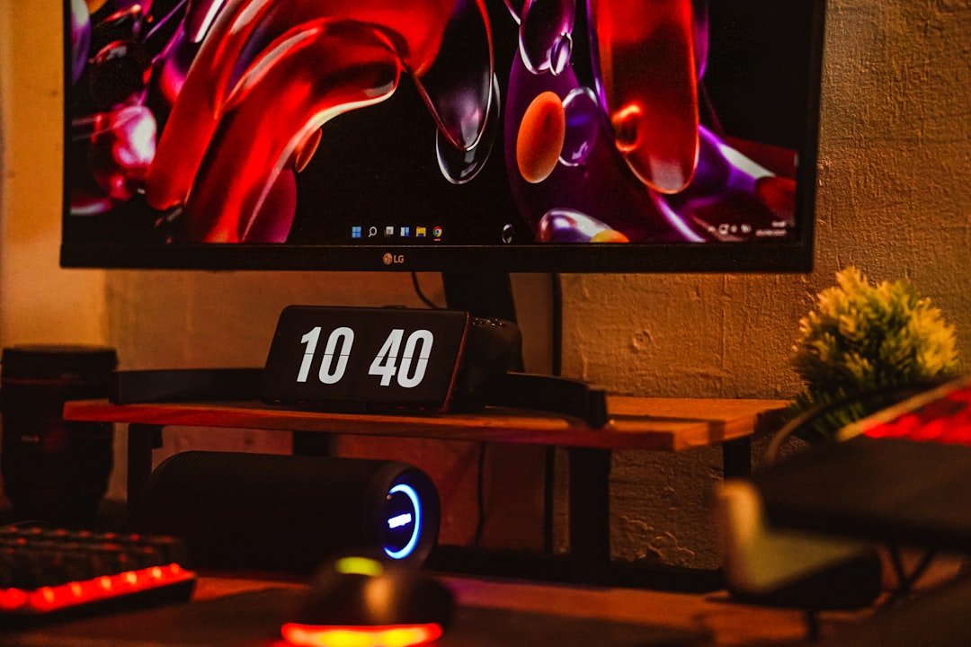 Competitive gamer at desk with multiple monitors reviewing gameplay footage